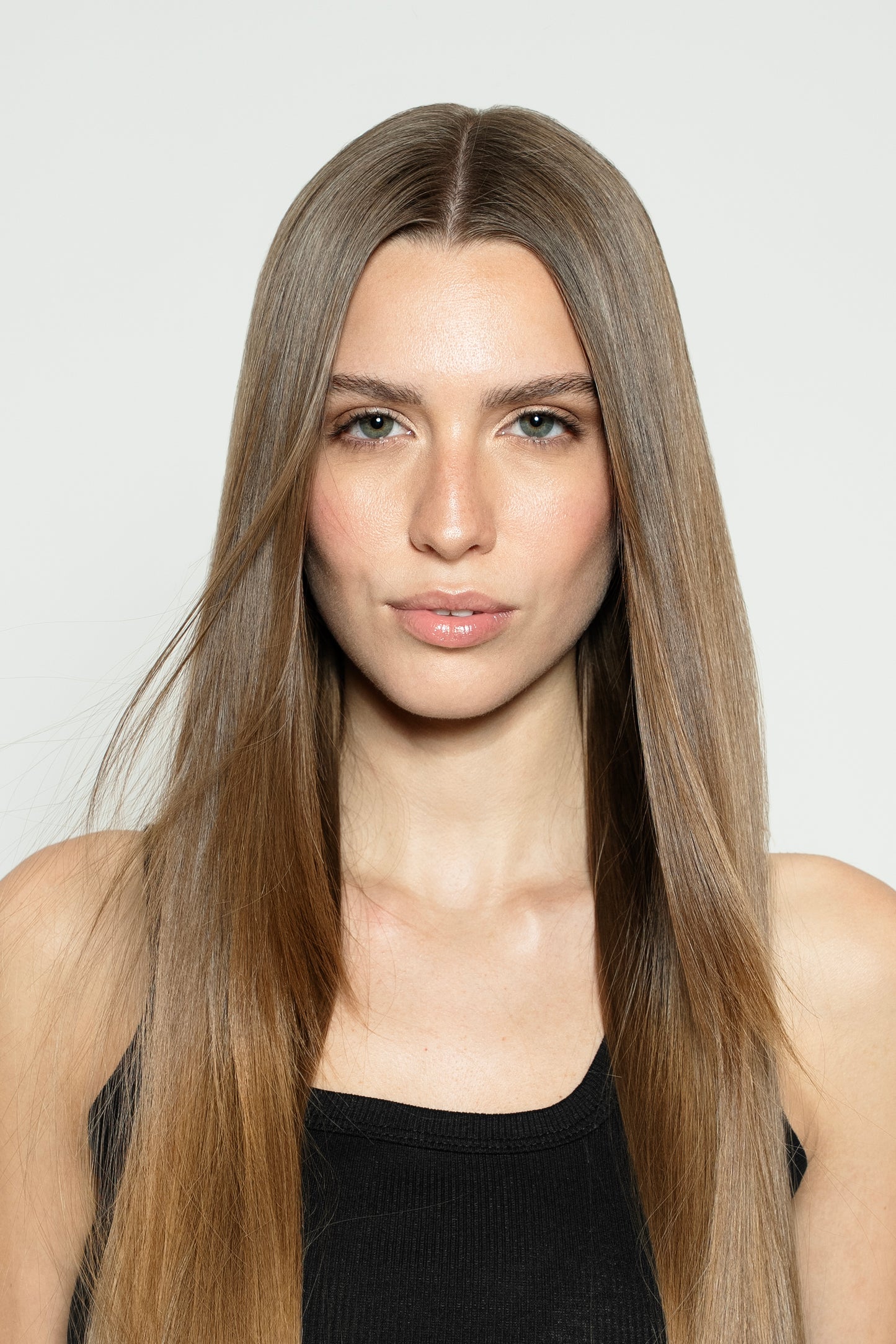Model with light brown clip-in hair extensions for a soft, natural brunette look