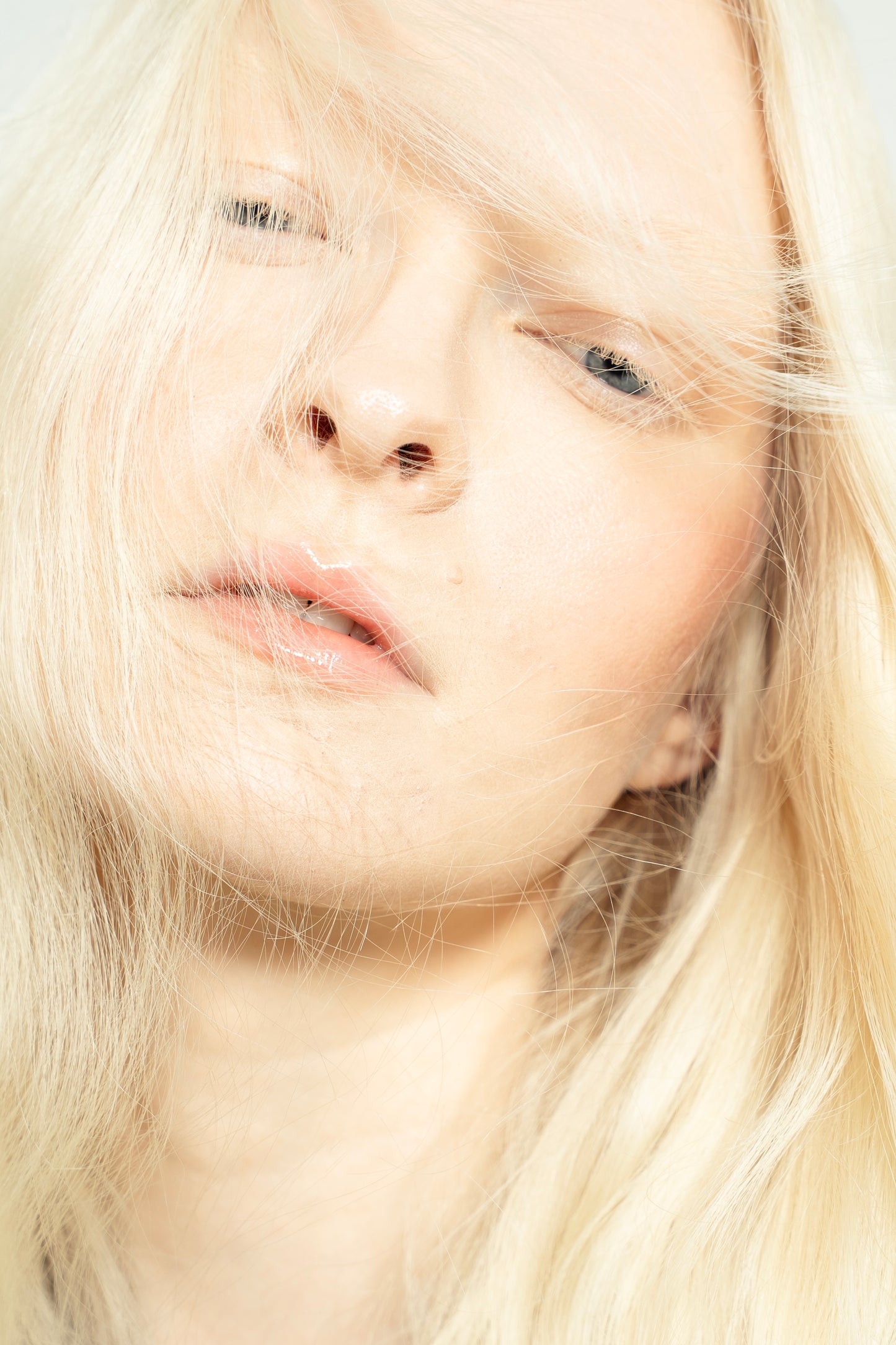1010 Extensions bright blonde clip-ins styled into soft curls for an everyday glam look