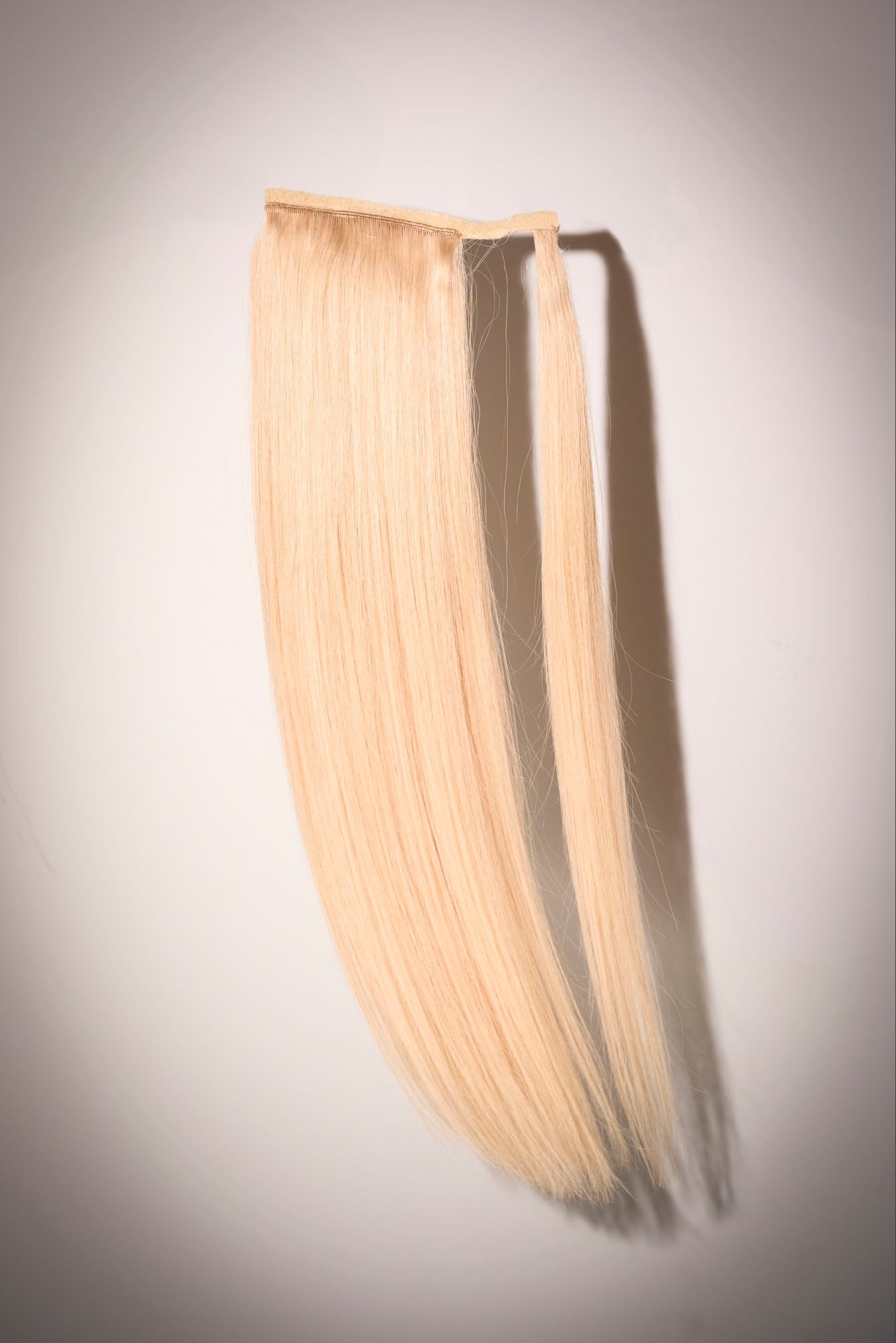 High ponytail in bright blonde styled with 1010 Extensions for a bold, lifted look