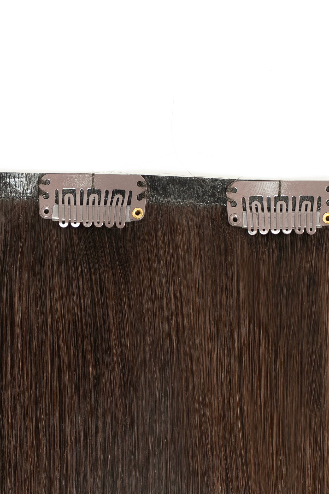 Dark brown clip-in hair extensions from 1010 Extensions for a bold, voluminous look