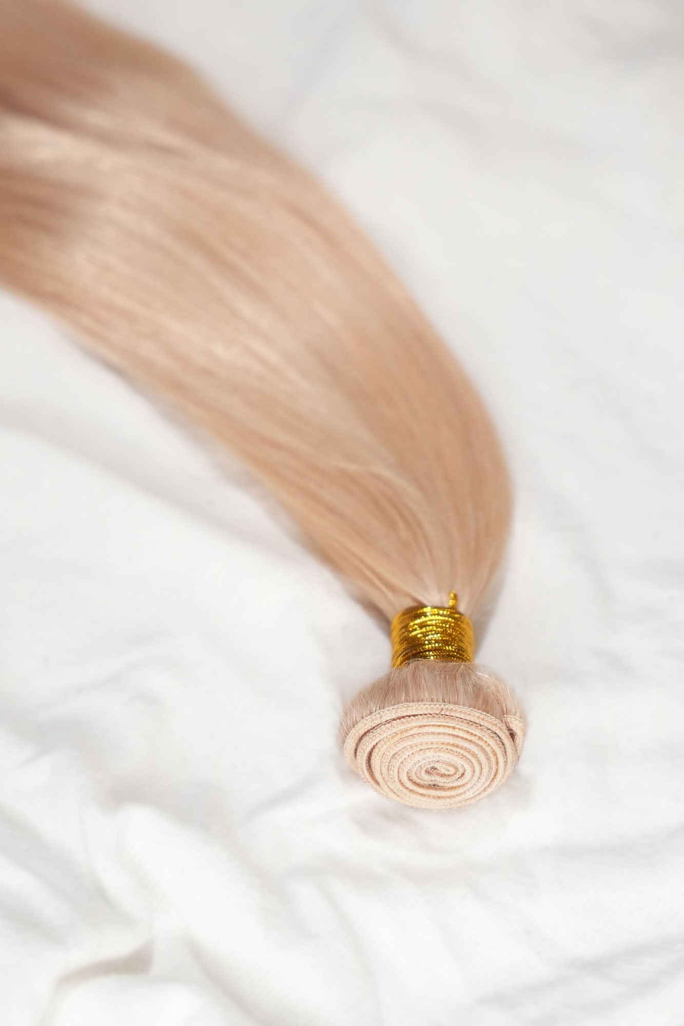 Bright blonde hair bundle from 1010 Extensions made with 100% virgin human hair and double-weft design