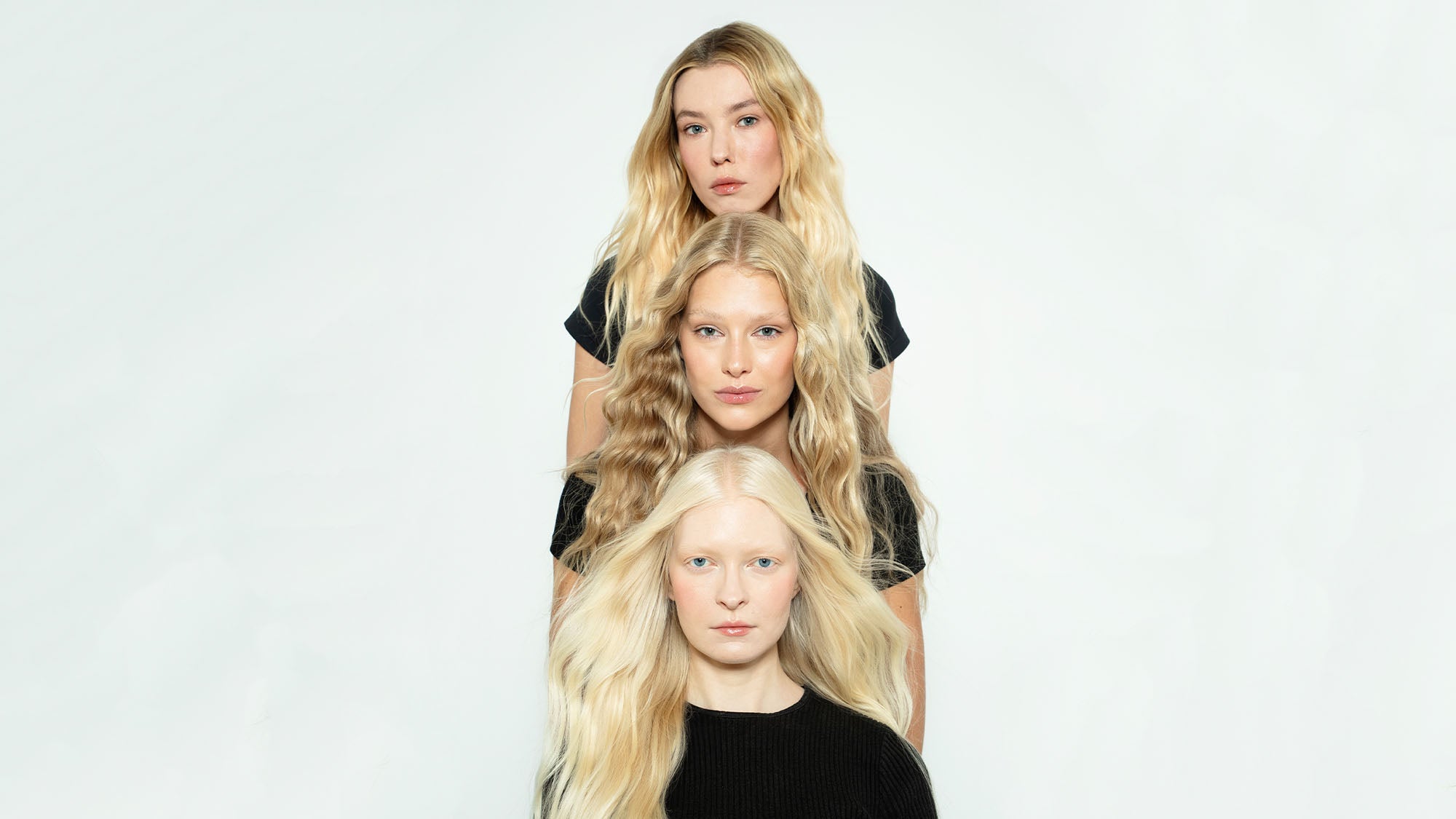 Group shot of models wearing premium tape-in hair extensions by 1010 Extensions, featuring colours from deep chestnut to soft honey blonde