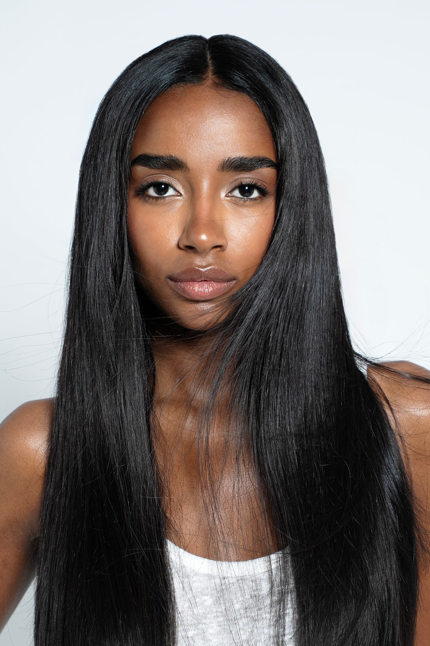 Model showcasing thick, natural black Remy clip-ins for a flawless blend