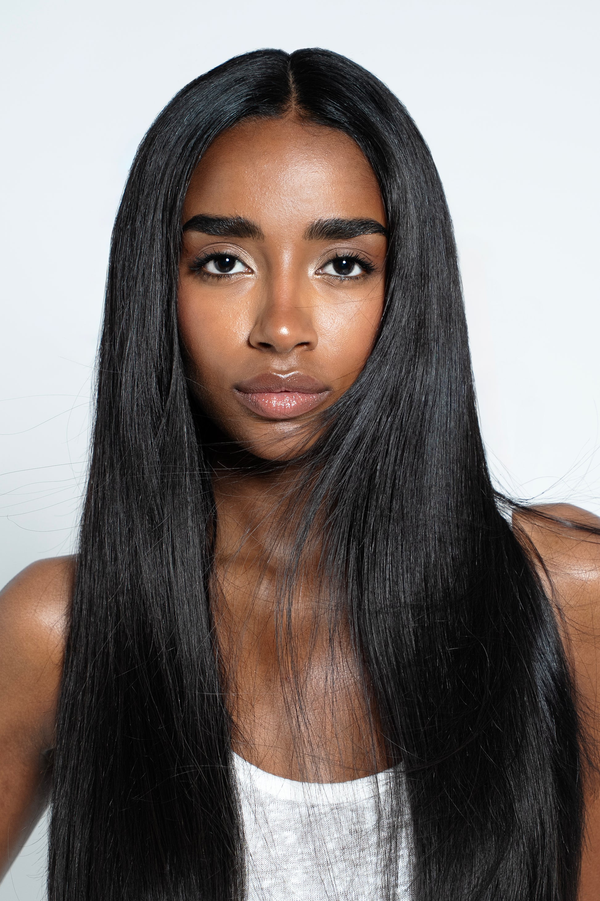 Model showcasing thick, natural black Remy clip-ins for a flawless blend