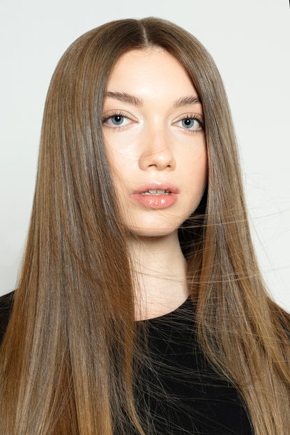 Model styled with warm brown human hair clip-ins for added depth and fullness