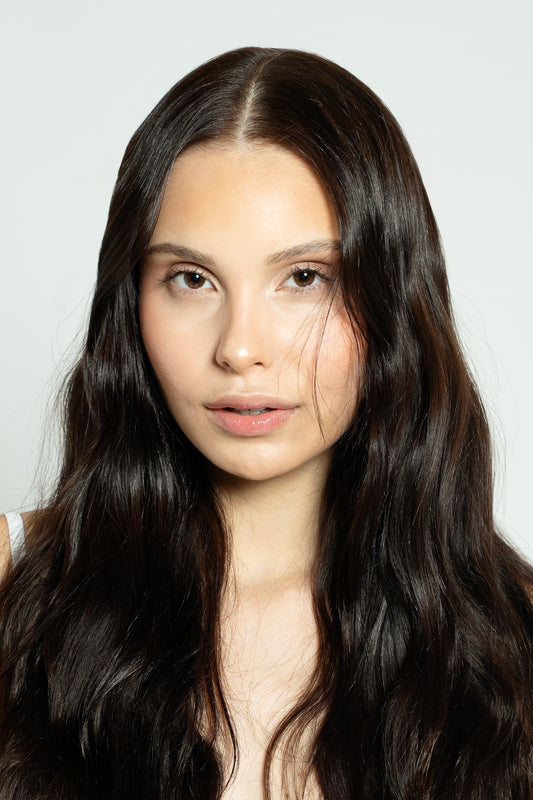 Model wearing silky dark brown clip-ins with seamless finish and natural shine