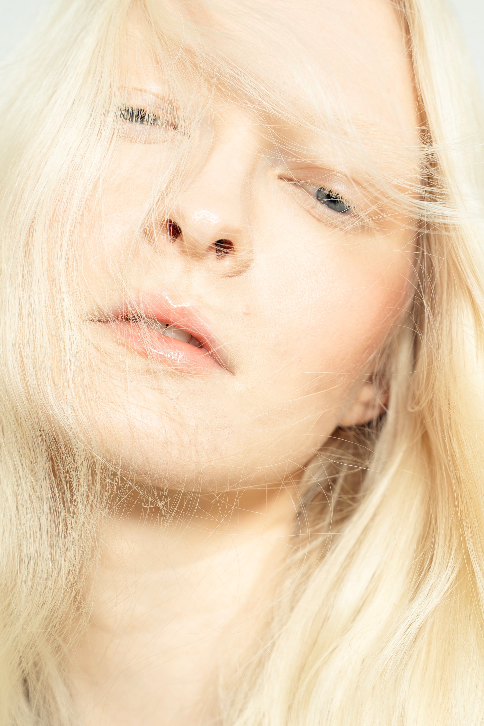 1010 Extensions bright blonde clip-ins styled into soft curls for an everyday glam look