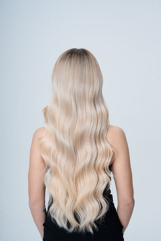 Model wearing silky straight bright blonde weft bundle for custom application from 1010 Extensions