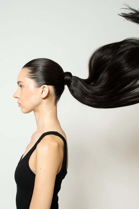 Model with natural black ponytail extension adding realistic length and fullness