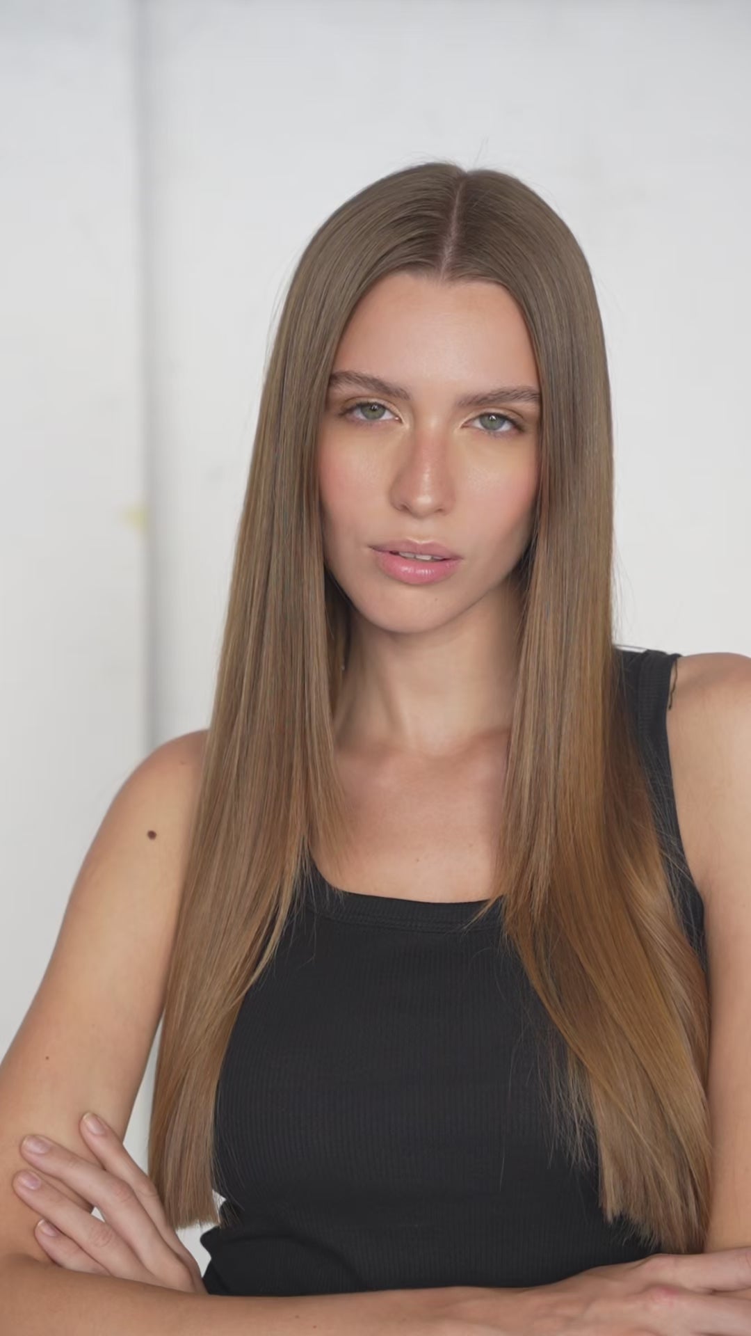 Close-up of silky light brown clip-in hair extensions with seamless attachment