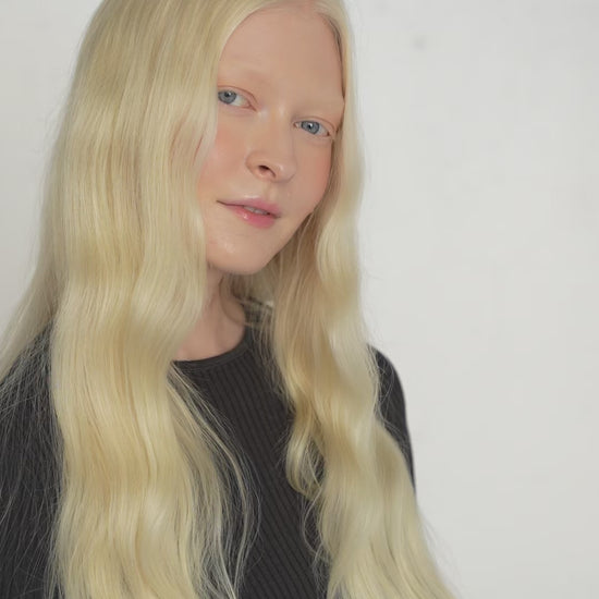 Model wearing 7-piece bright blonde Remy clip-ins with a seamless, natural blend