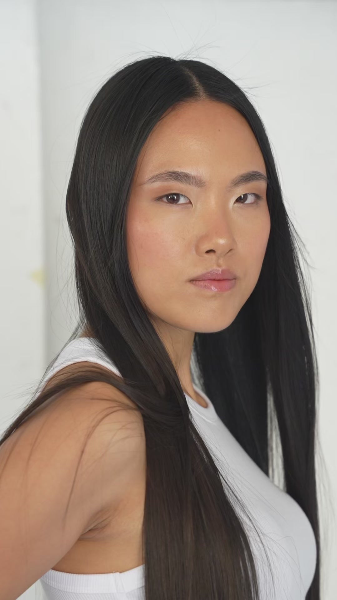 Glossy noir black 7-piece Remy clip-in set for a sleek, bold look by 1010 Extensions