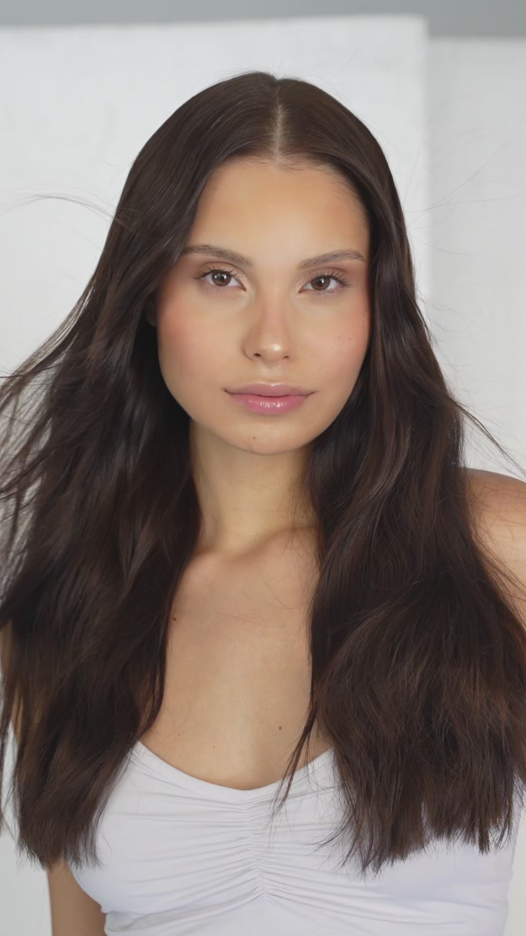 1010 Extensions dark brown clip-ins styled straight for a sleek, full finish
